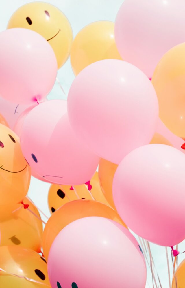 low-angle photo of pink and orange balloons