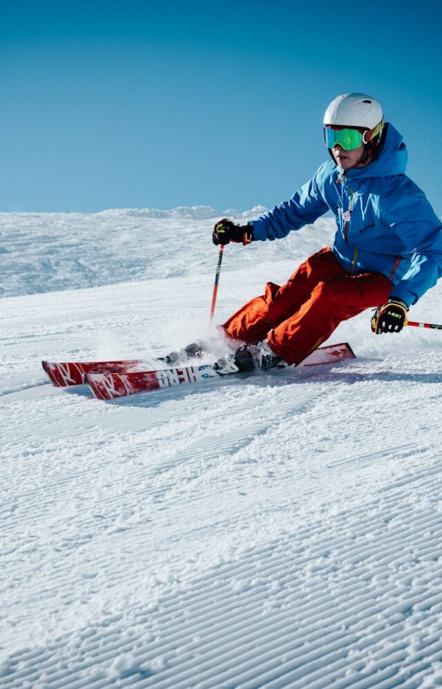 man ice skiing on hill